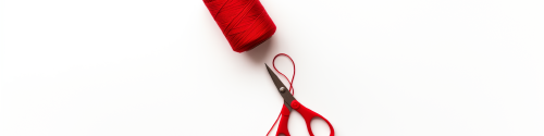 red cotton yarn, white background, scissor cutting through a strand